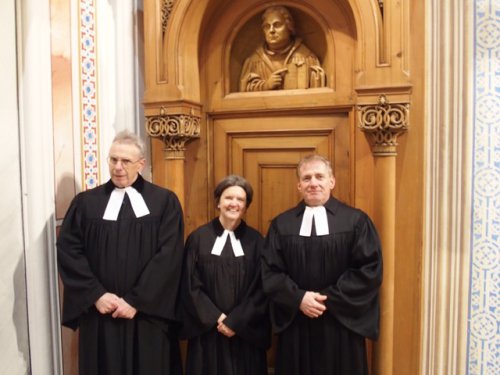 Alt-Superintendent Werner Horn und das Gumpendorfer Pfarr-Duo Edith Schiemel und Michael Bickelhaupt. Über den Dreien: Martin Luther (Holzskulptur)